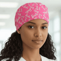 Person wearing a pink 'Barbie' scrub cap with a blurred background